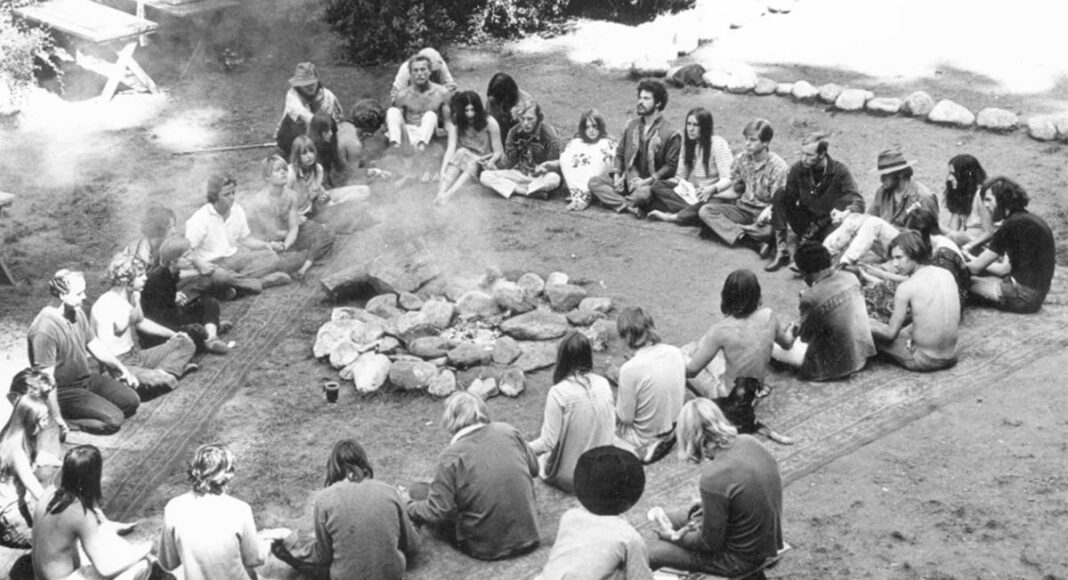 Residents of Ben Lomond's Holiday Cabins commune sit in a circle outside
