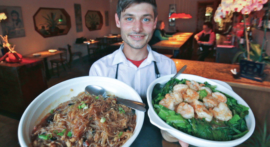 Jordan Chesko of Oâ€™mei with â€˜Ants Climbing a Treeâ€™ dish and garlic prawns with bok choy.