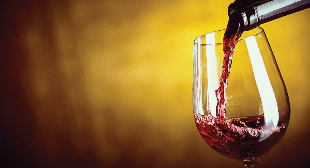 red wine being poured into a glass