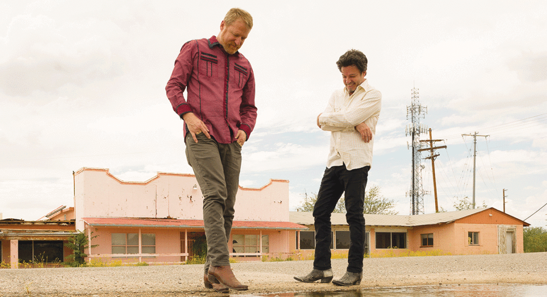 Members of the band Cracker in front of abandoned store front