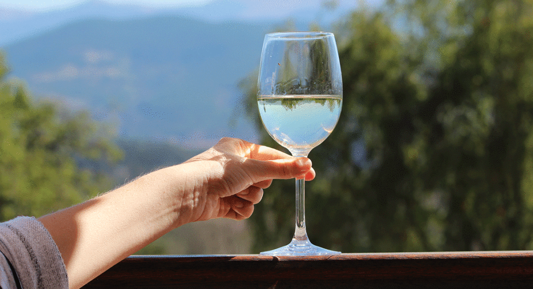 Margins Wine white wine on a porch in front of mountains