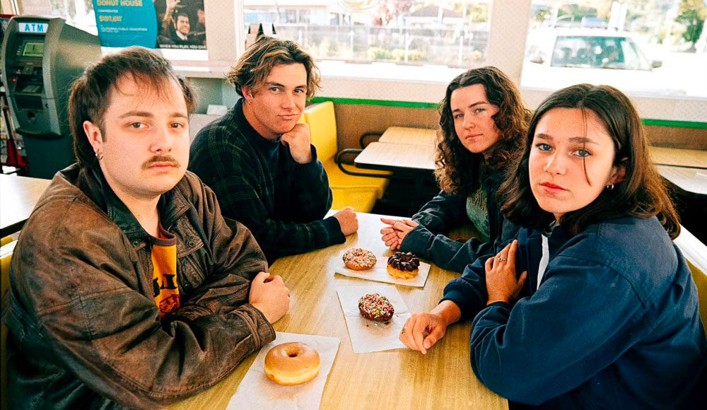 Four people sitting at a restaurant table