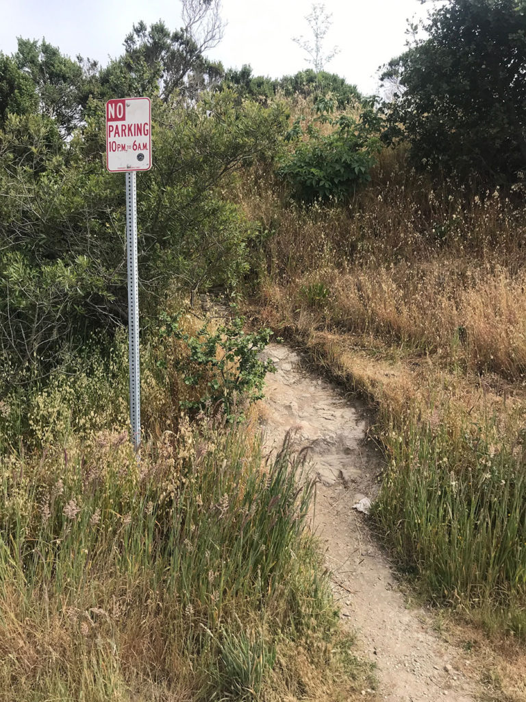 Narrow path by a no-parking sign