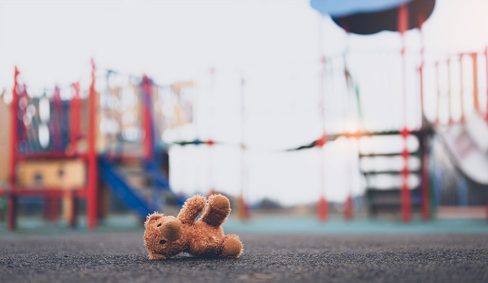 teddy bear abandoned on a street