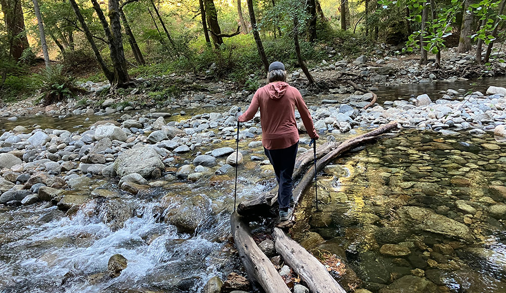 Woman walking across a river
