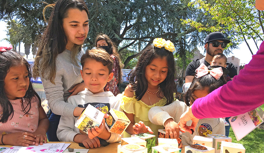 Group of kids outside at a table