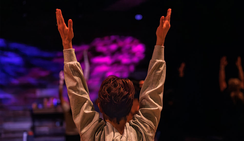 Woman seen from behind, stretching her arms