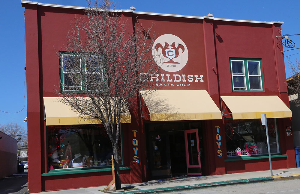 Red stucco storefront with yellow awning