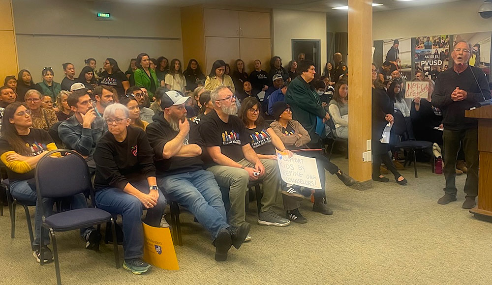 Speaker at podium and people in the audience