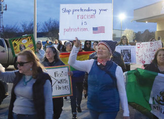 Trump Viewing Party Draws Supporters, Counter-Protest People protesting with signs