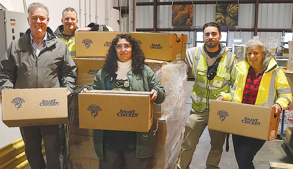 People holding boxes in a warehouse