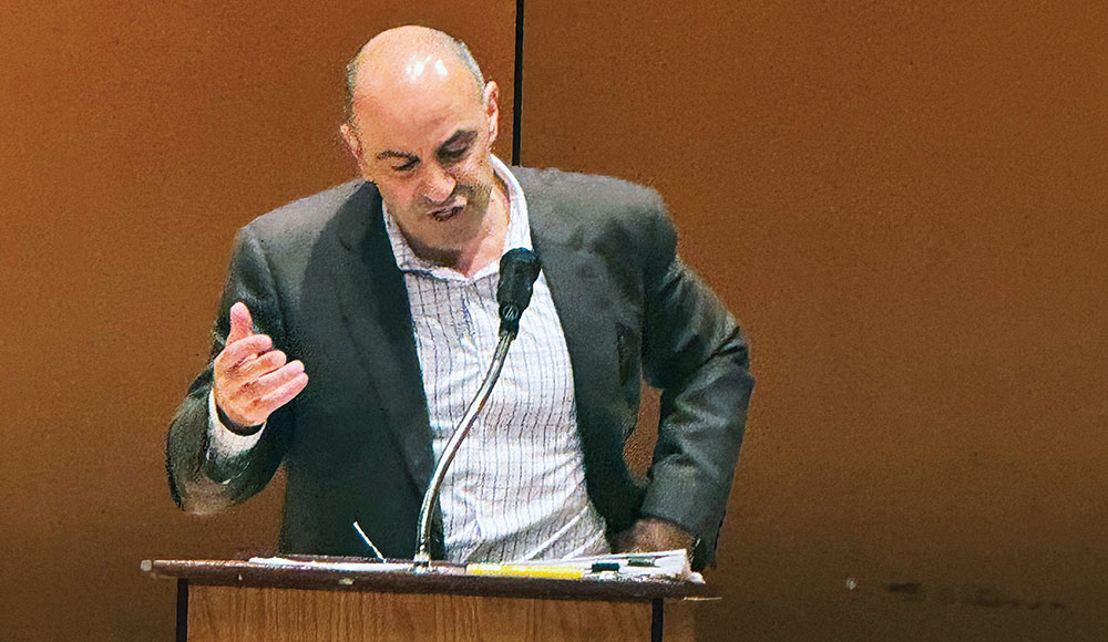 Man speaking at a podium