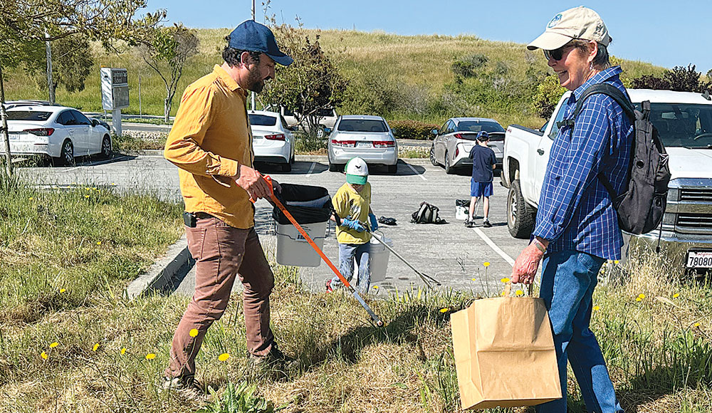 Two people picking up trash