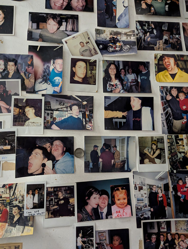 Photo of snapshots affixed to a wall