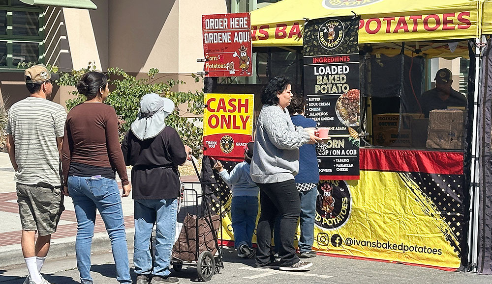 Four people lined up at a booth