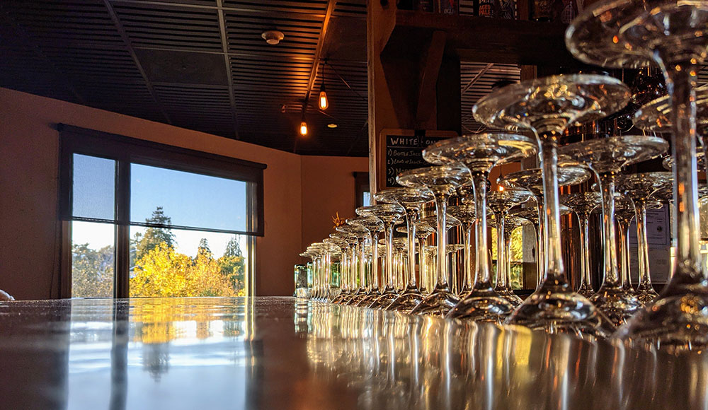 Row of glasses with window in background