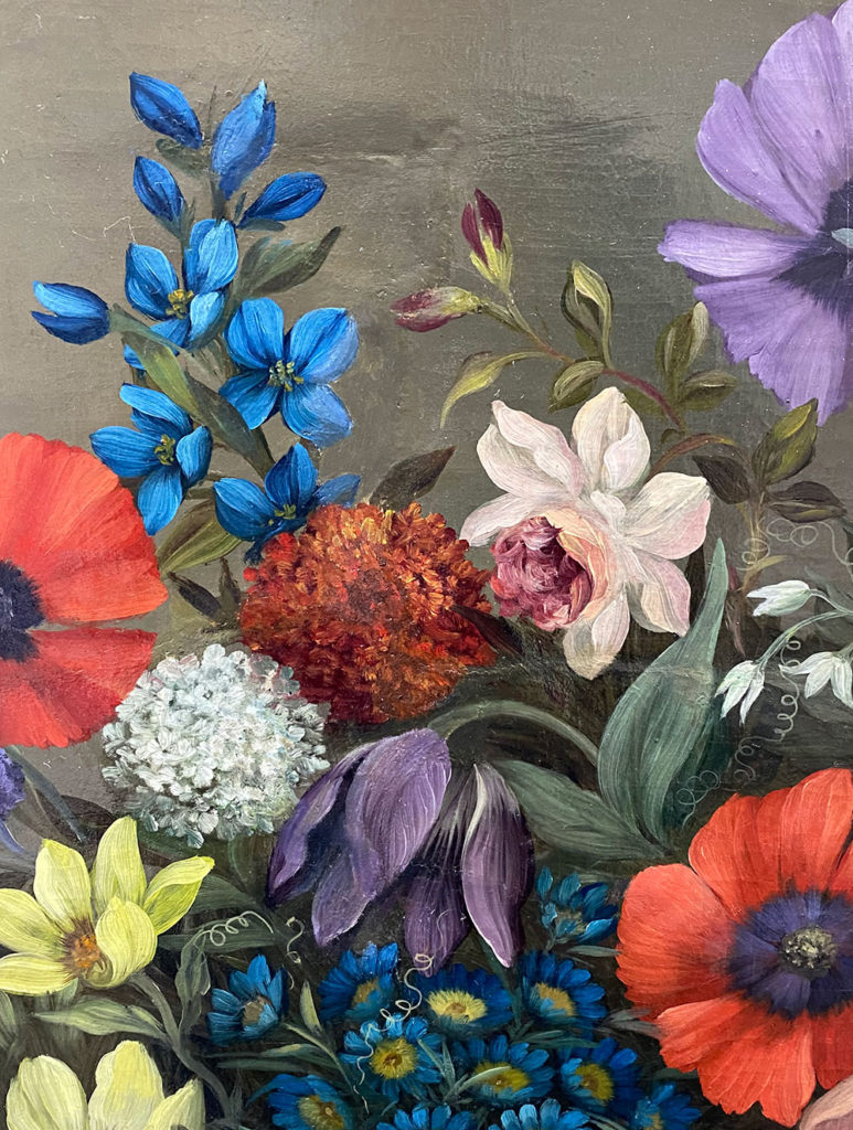 Close-up of a restored floral oil painting showing vivid blue, red, purple, and yellow flowers with smooth, repaired surface.