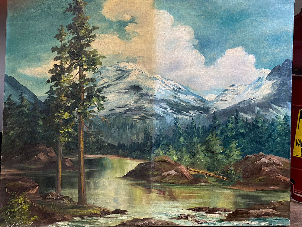 Landscape painting showing half-cleaned restoration, with one side bright and clear and the other darkened by age and varnish.