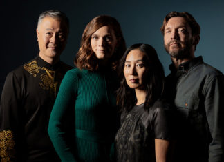 East Greets West Members of the Del Sol Quartet pose together against a dark blue background.