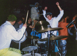 Quite a Pickle A drummer plays onstage as a costumed, energetic crowd surrounds him during an intense live Slow Gherkin performance.